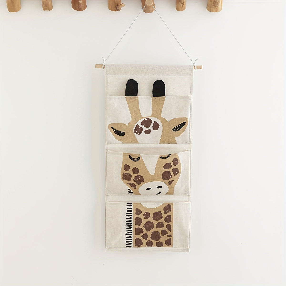 Fabric giraffe-design wall hanging storage organizer with 3 pockets, can be mounted over a door for waterproof linen closet pouch in bedroom, bathroom, or other rooms.