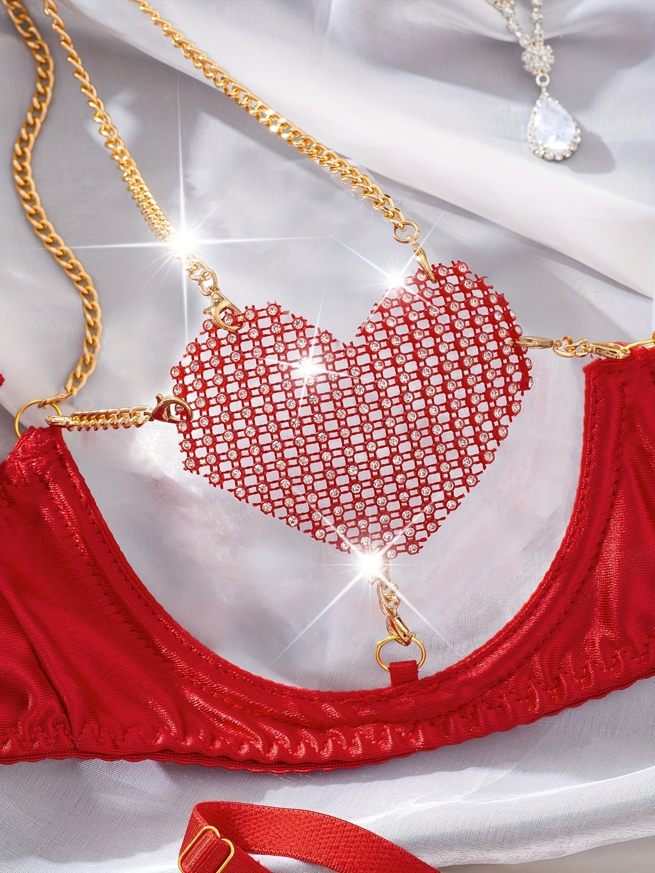 Heart-patterned lingerie set includes sheer bra and thong made of stretchy polyester blend, hand washable.