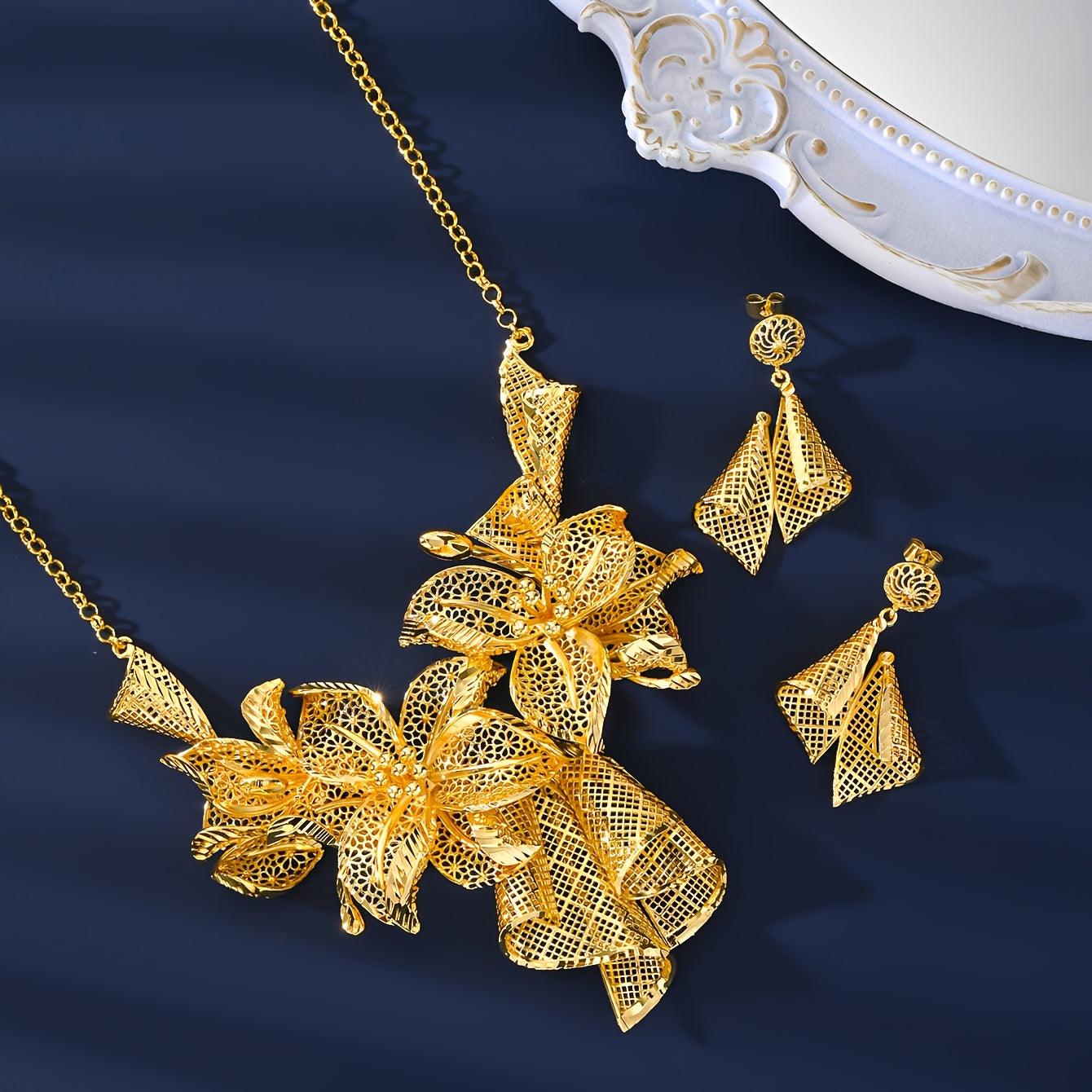 A luxurious jewelry set plated with 18K gold, showcasing a stunning floral necklace, a versatile adjustable ring, and charming pendant earrings - ideal for both everyday wear and special occasions.