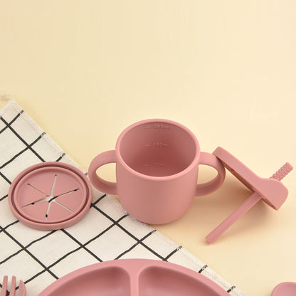 This set includes 9 pieces of feeding cutlery made of food-grade silicone, featuring a silicone bib, suction dinner plate, suction bowl, wooden handle silicone spoon and fork, food supplement spoon and fork, two-in-one drinking training cup, and eating