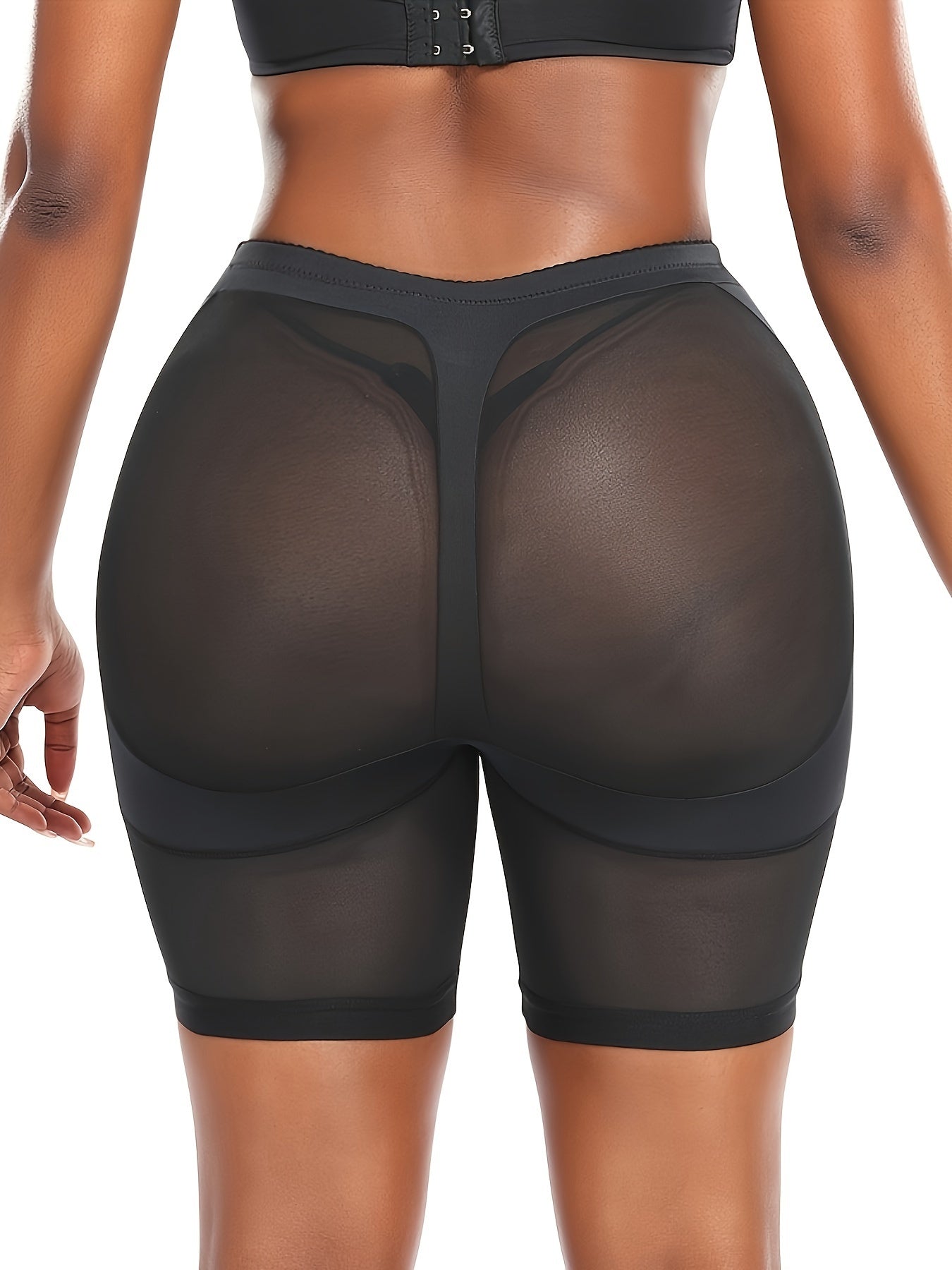 Slimming black shapewear shorts with high waist, tummy control, mesh panels, and a golden zipper detail. Made from a stretchy blend of polyester and elastane, providing mid-support.