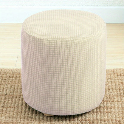 Stretchable round footstool cover made from soft polyester blend with elastic fit. Available in multiple colors, machine washable, modern design for living room ottomans.