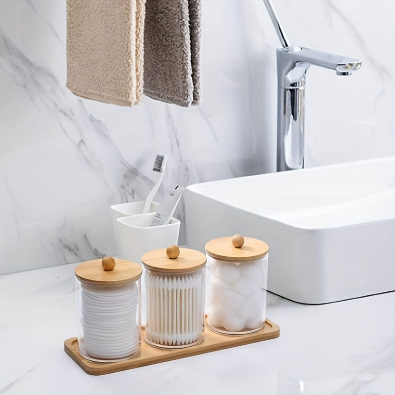 Set of 3 cotton swab/ball/pad holders with tray, apothecary jar with wood lids, and clear bathroom storage containers.