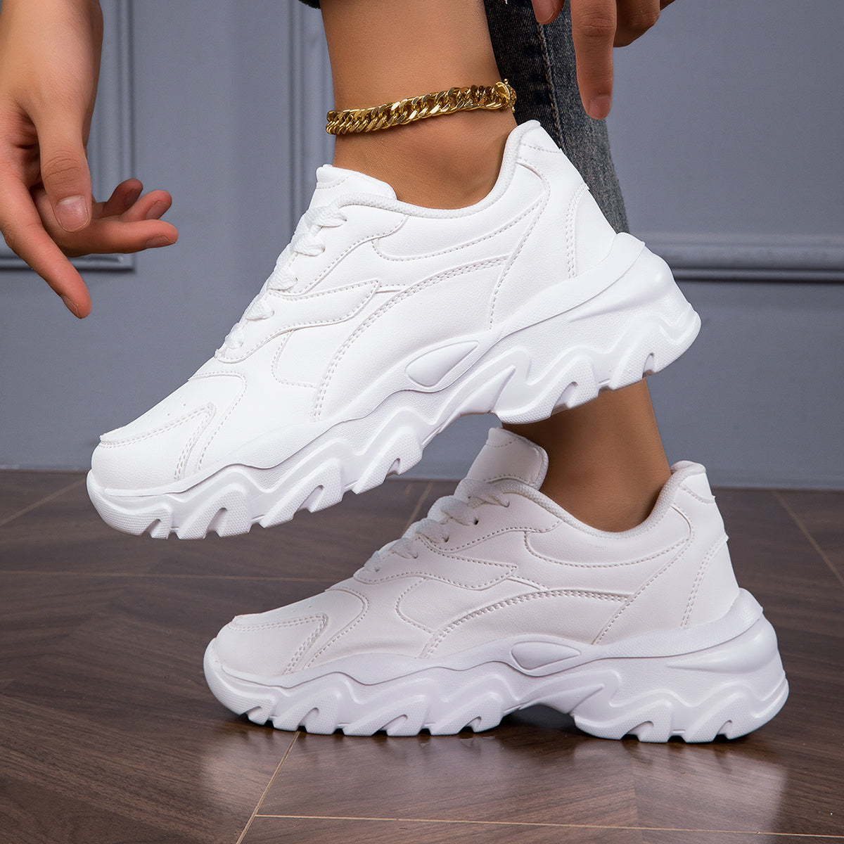 Women's white low-top lace-up sneakers for casual walks and shopping.