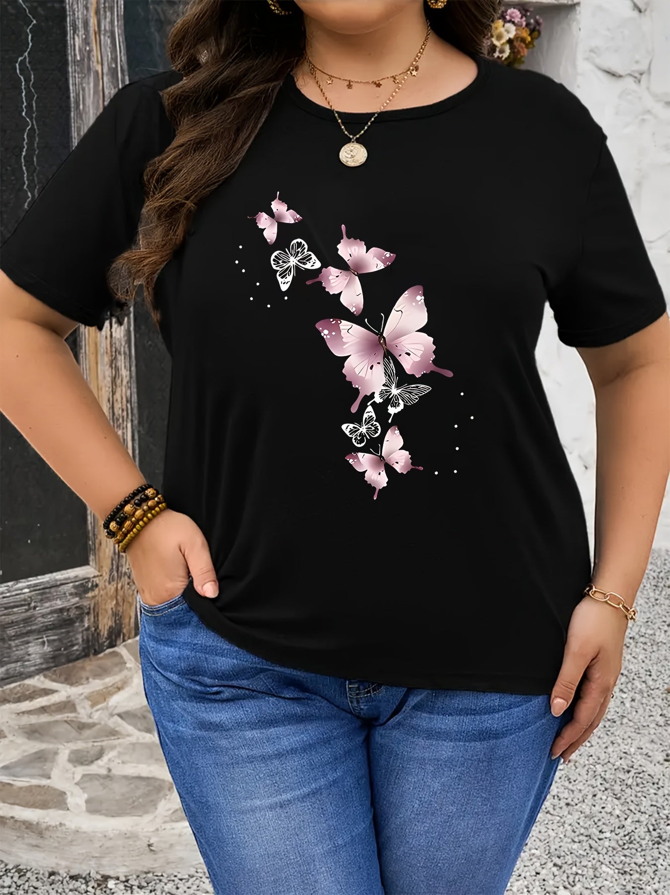 Stylish plus size pink butterfly print t-shirt for women, crew neck, short sleeve, stretchy polyester blend, machine washable. Ideal for spring/summer.