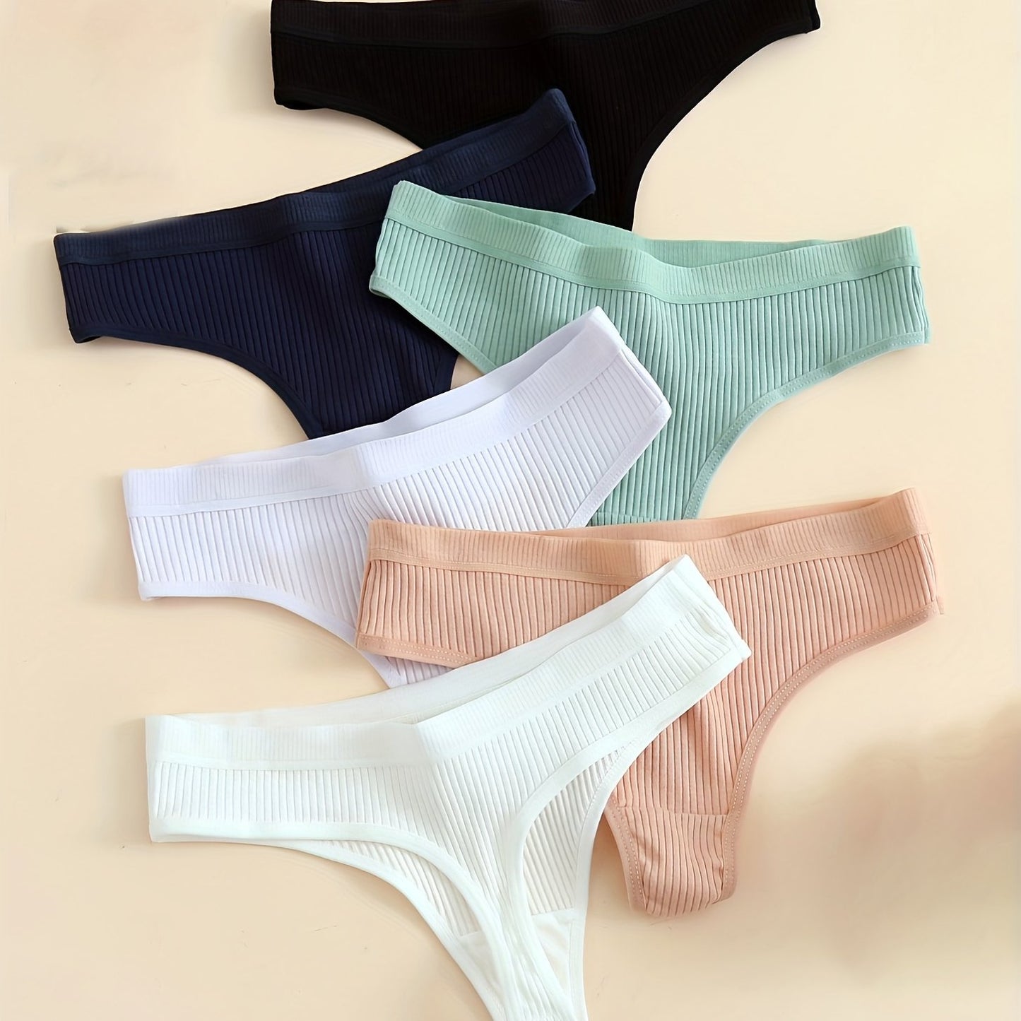 6-Pack of comfortable seamless cotton thongs for women, v-string style with low waist, solid color, simple design, and non-see-through fabric.