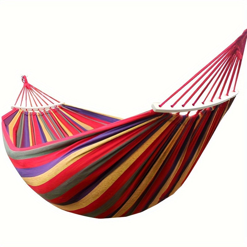 Heavy-duty rainbow canvas hammock for single or double with curved wooden sticks and a weight capacity of 226.8 KG. Includes tree straps for camping, backyard, or patio. High-strength