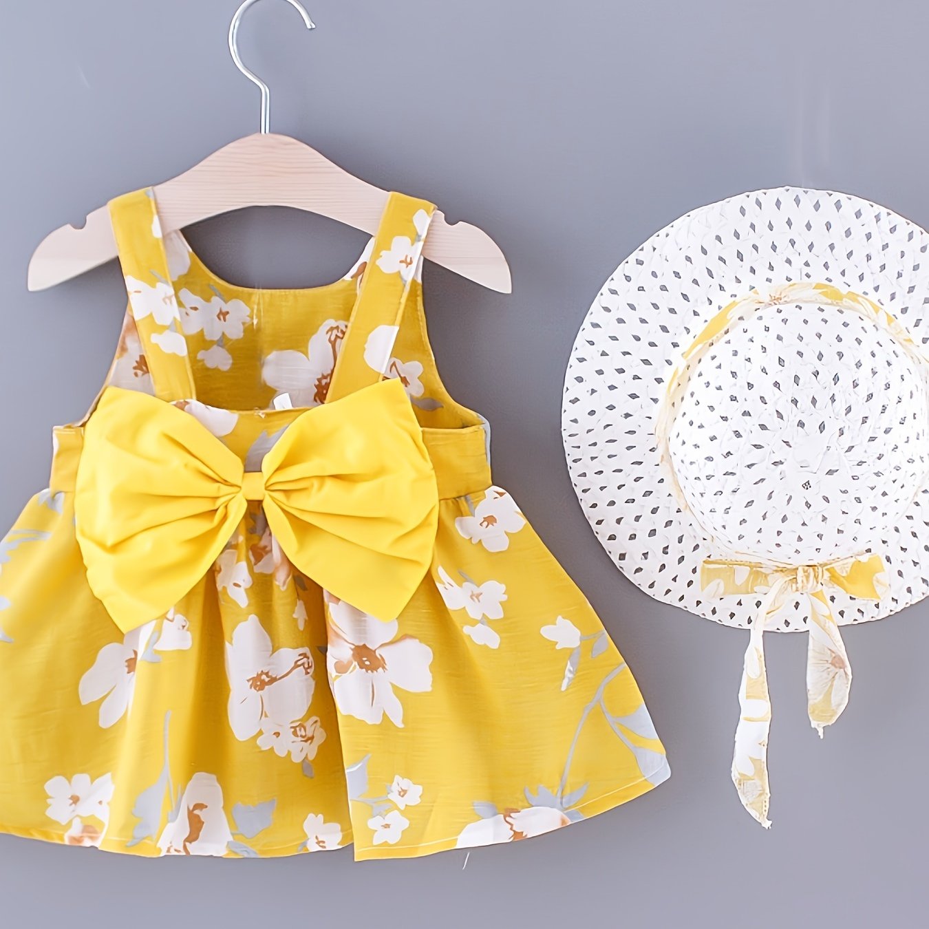 Summer dress with flower print, big bow, and matching hat set for baby girls.