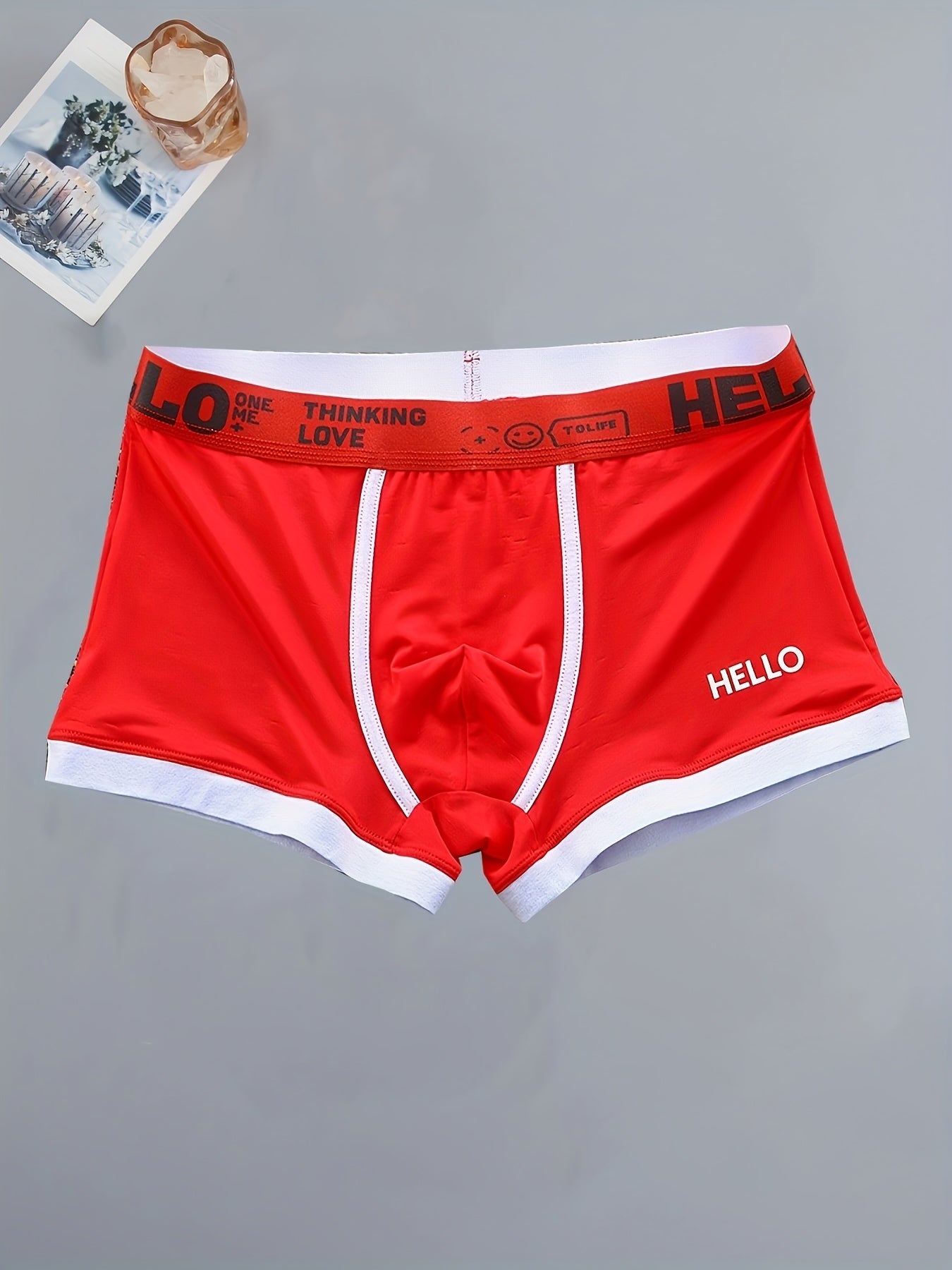 4 men's boxer briefs made with soft, breathable polyamide and elastane fabric featuring an alphabet pattern.