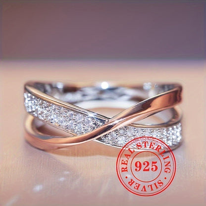 This elegant and simple women's fashion ring is crafted from sterling silver 925, featuring a two-tone Mobius band design adorned with pave cubic zirconia. Perfect for daily wear or special occasions, this stylish piece weighs 0.12oz and adds a touch of