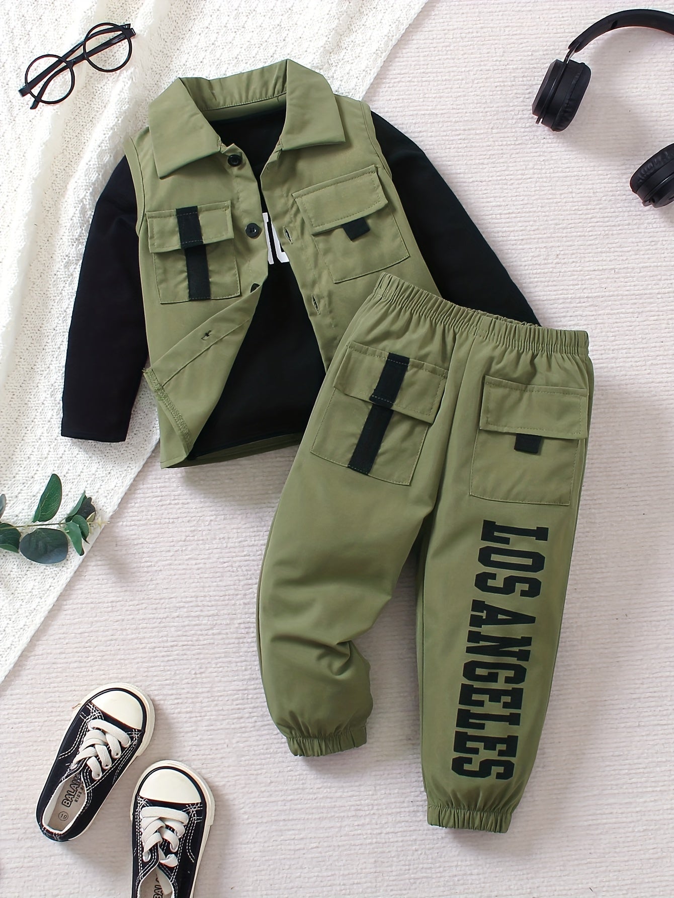 3-piece boys' street style outfit set includes olive green vest with flap pockets, LA print long sleeve tee, and jogger pants. Made of 100% polyester, machine washable for spring/fall.