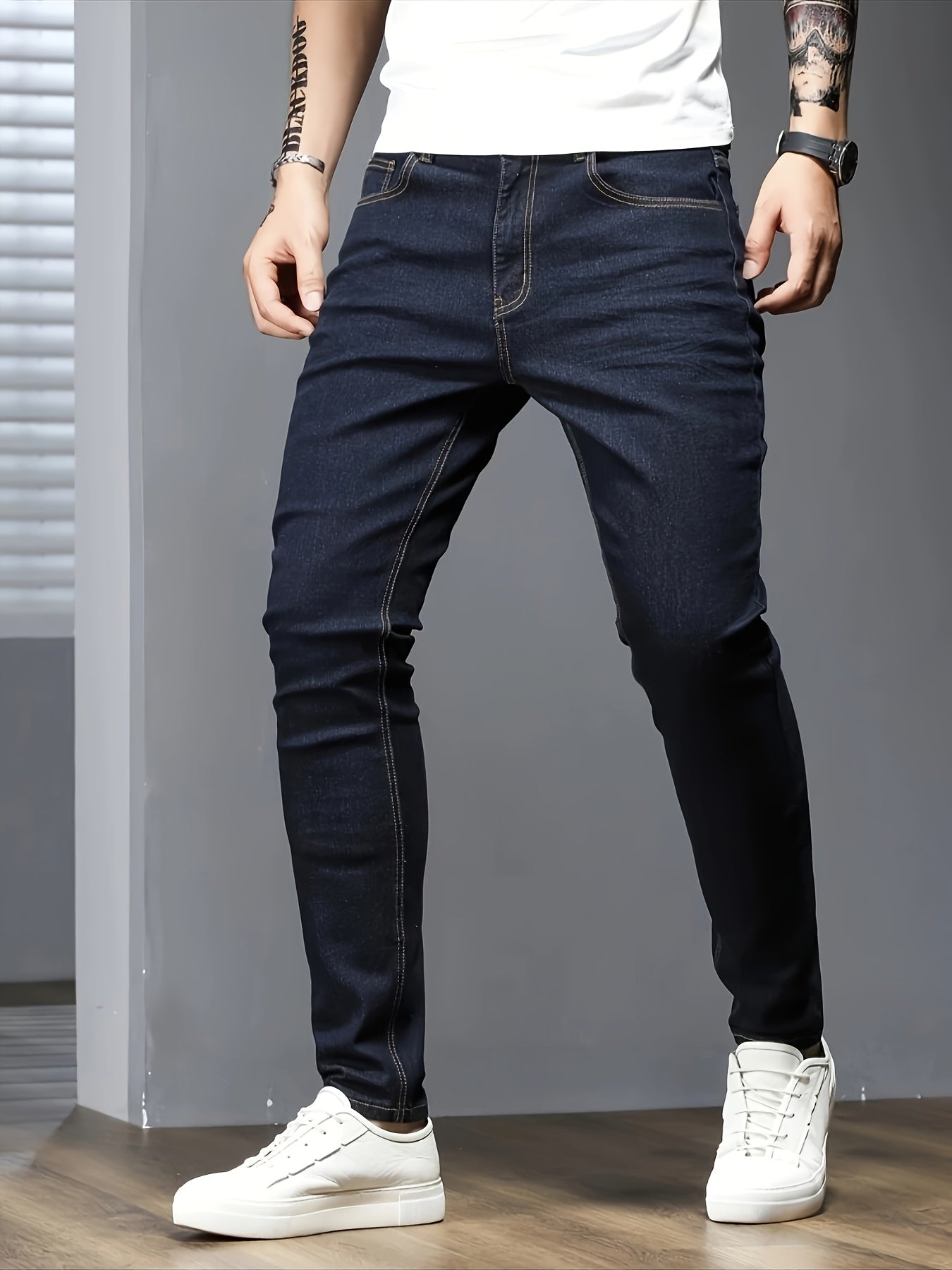 Men's slim fit jeans in solid color, made with stretch denim fabric and raw wash detail, suitable for all seasons.