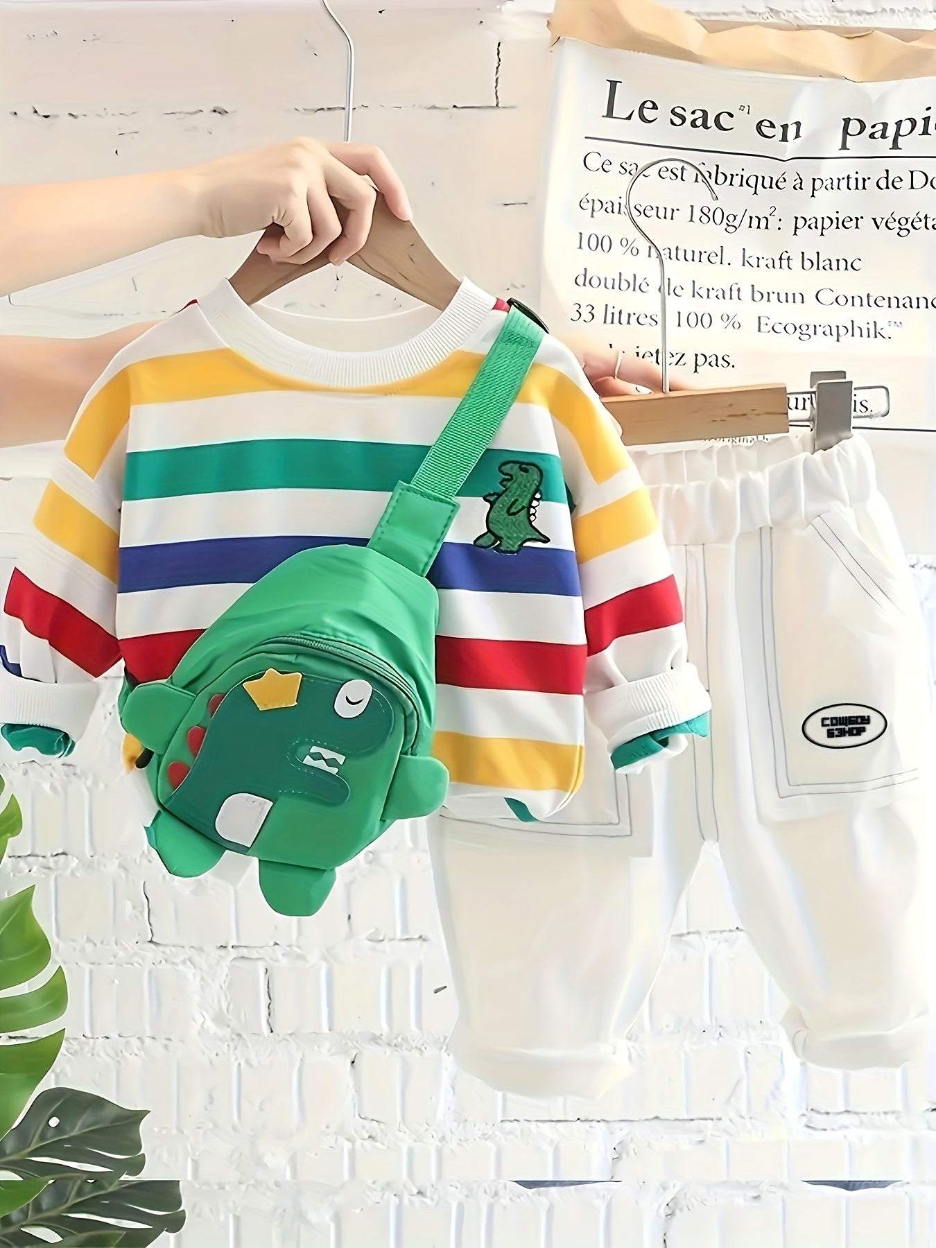 Kids' Autumn 2-piece outfit set with colorful striped long sleeve top, green dinosaur jeans, and cute bag. Made of cozy polyester blend for boys and girls. Offers spandex comfort fit, ideal