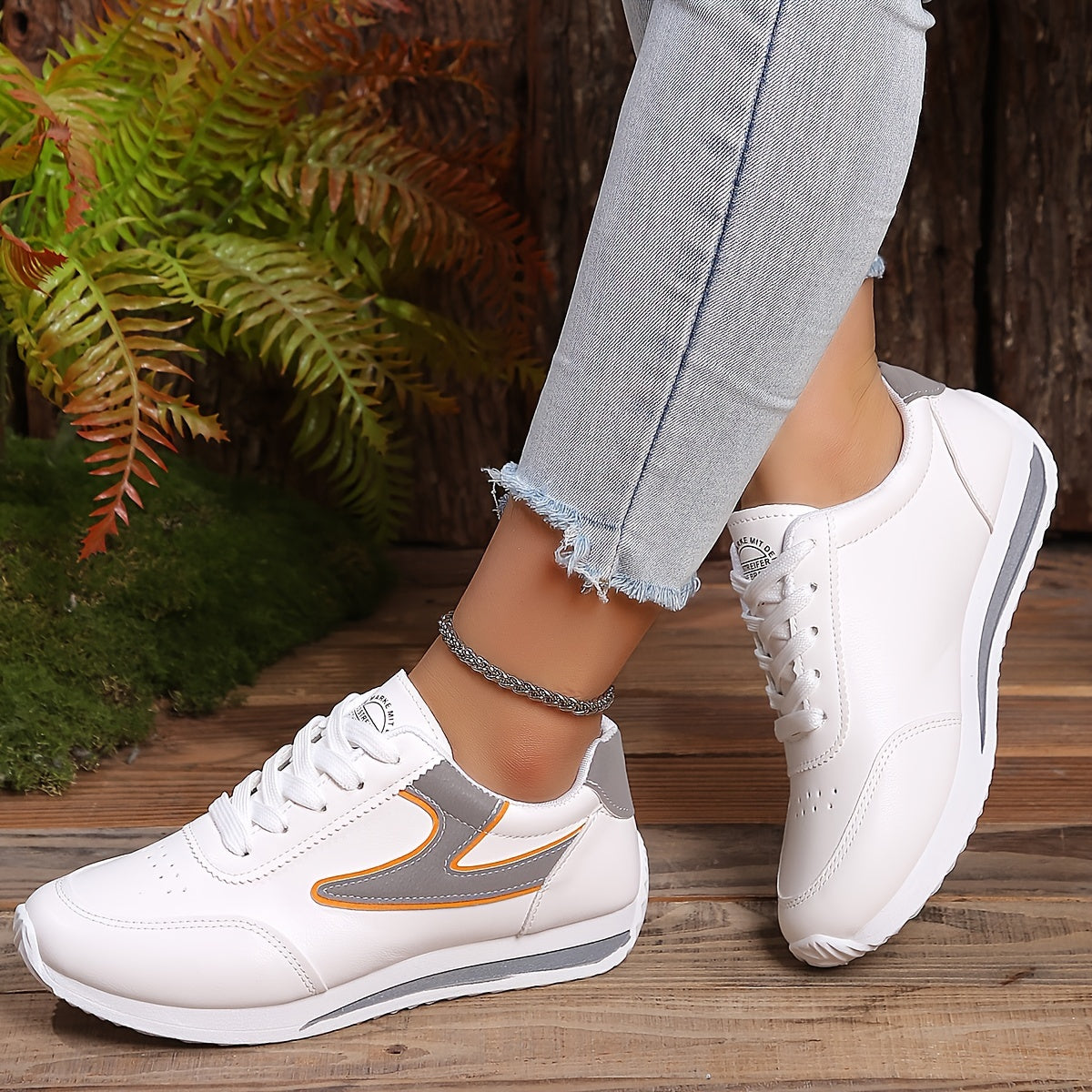 Women's flat lace-up sneakers for outdoor casual wear, comfortable low top shoes.