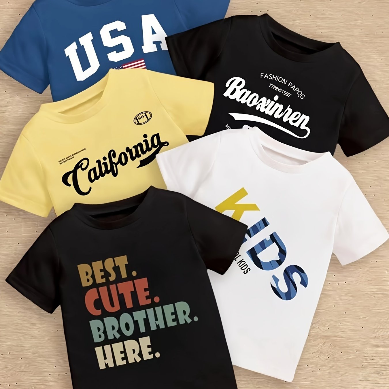 5-piece boy's summer casual tee with various prints: 'USA', calligraphy letter pattern, 'KIDS...', 'BEST CUTE...', and 'CALIFORNIA...'. Cool, comfy, and versatile gift option.