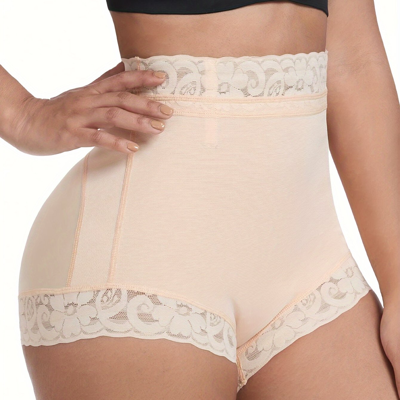 High-waisted shaping shorts for women with tummy control and butt lifting features. Made of stretch nylon with floral lace trim, in beige color. Hand wash only. Cute panties.