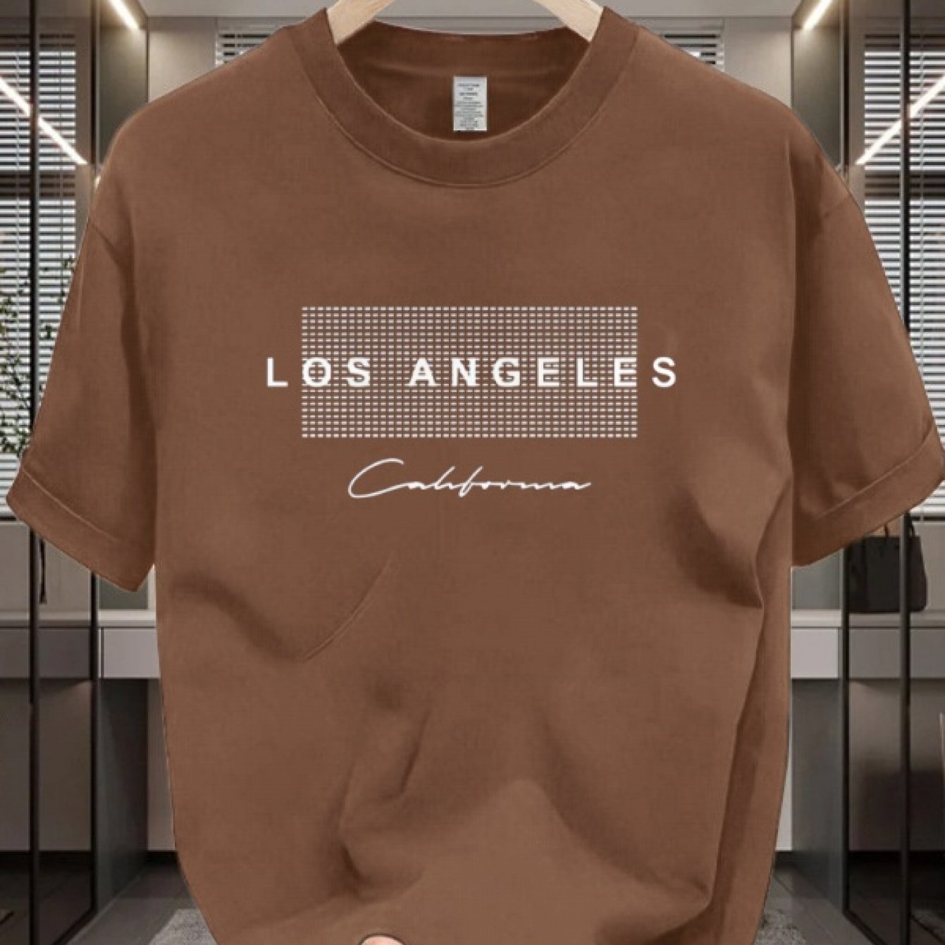 Men's casual cotton T-shirt with crew neck and short sleeves. Made from 100% cotton knit fabric, providing all-season comfort. Features a solid color and a Los Angeles California graphic