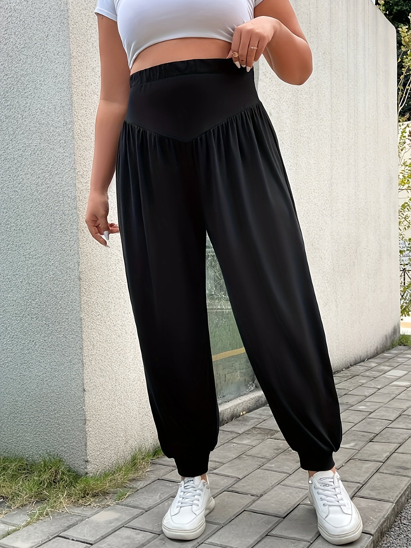 Plus size women's casual black wide-leg pants with a cozy fit and pleated detail. Made from a stretchy polyester blend for comfortable wear. Ideal for spring, summer, and fall. Perfect for