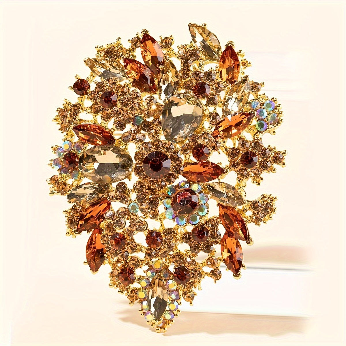 Trsince Brand offers an elegant and luxurious rhinestone brooch pin featuring an irregular shape and gold plated sparkly gemstones, perfect for any woman looking for a unique and stylish accessory.