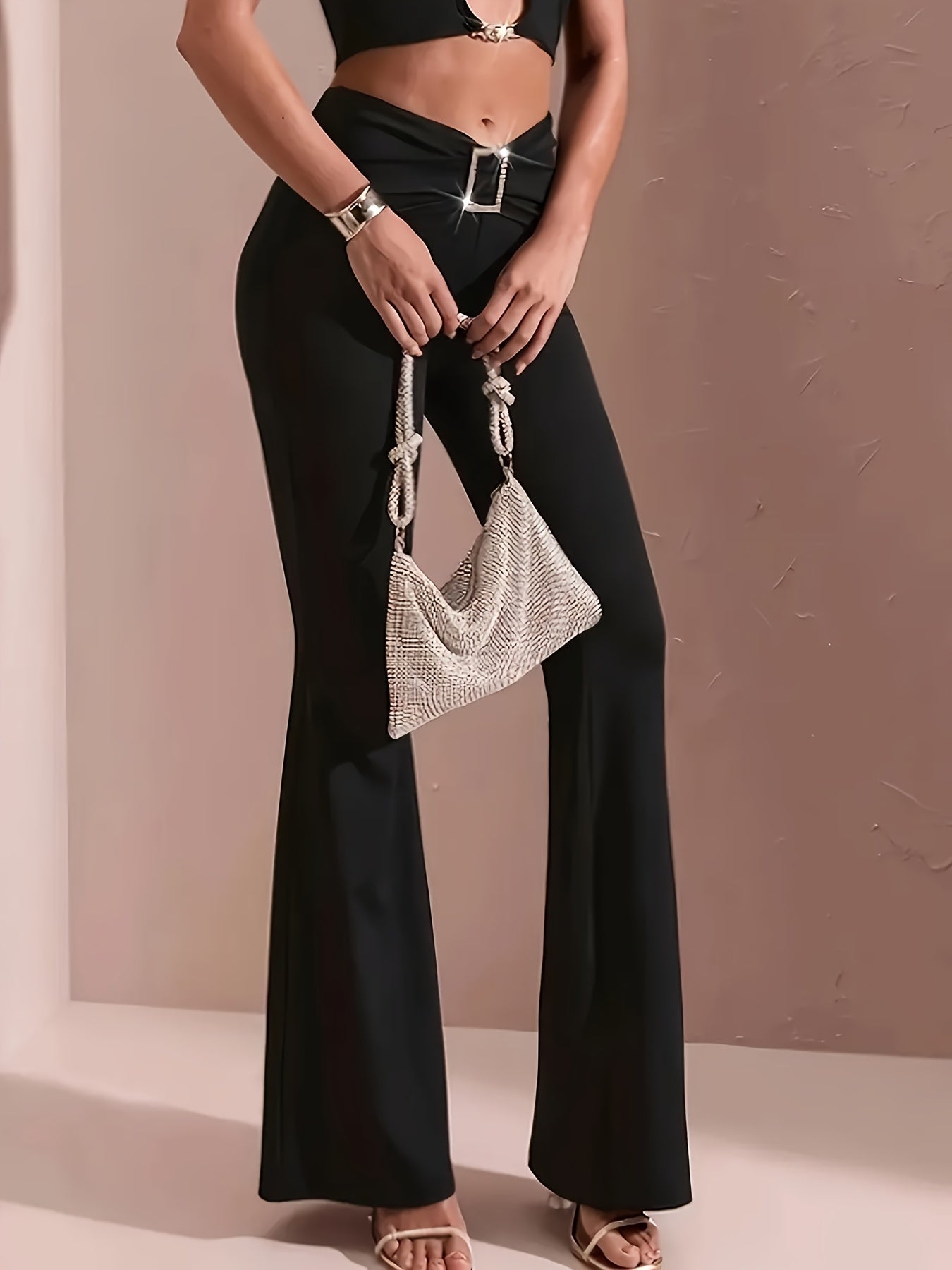 Elegant solid black high-waist flared pants with glossy finish, made from stretchy polyester and spandex blend. Comfortable bell bottoms for casual or dressy occasions.