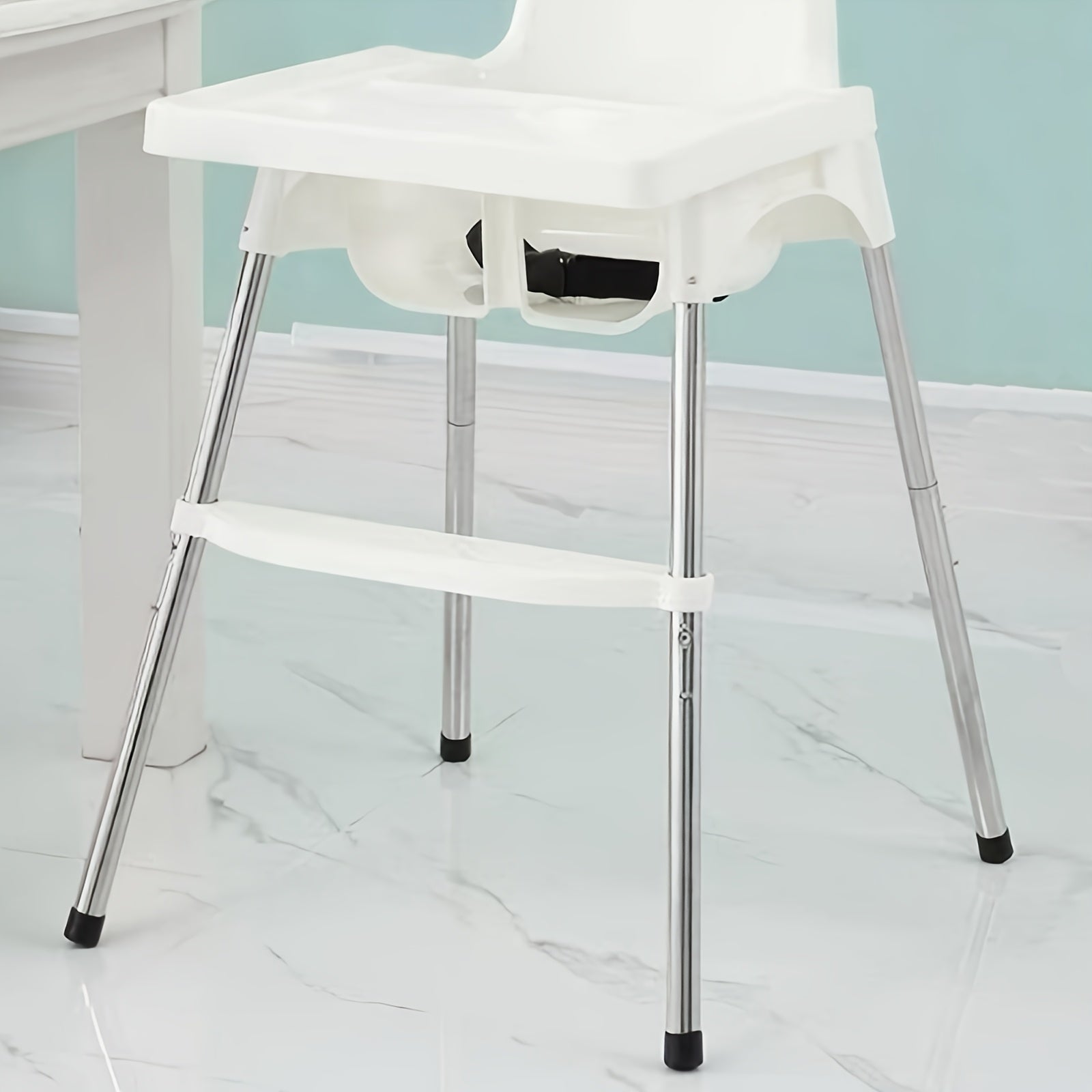 This footrest for high chairs is adjustable and features non-slip lightweight plastic. It is designed to be compatible with high chair accessories and includes stabilizing rubber rings. No assembly is required.