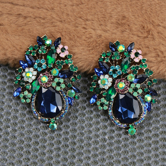 Vintage luxury flower brooches featuring rhinestones and enamel - set of 2. These unique brooches have an irregular shape and are perfect for adding flair to dresses, sweaters, corsets, and badges.