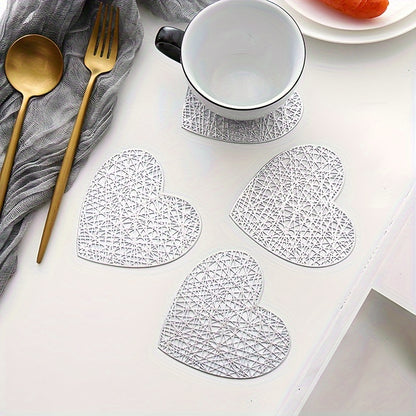 Set of 4 heart-shaped placemats and coasters made of PVC with heat insulation and non-slip features, ideal for household decoration and meal protection on dining tables.