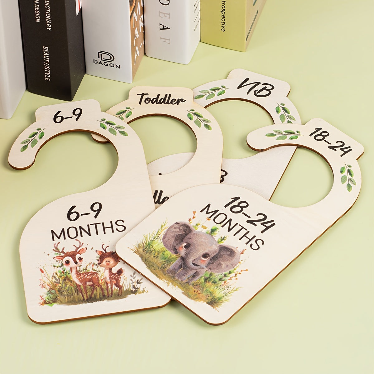 8 wooden closet dividers featuring cute animal themes for organizing clothes in a wardrobe for 24 months.