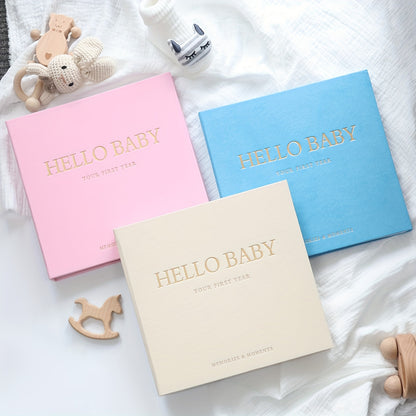 Linen memory book with golden logo, spiral bound journal with 86 pages, includes 12 monthly milestone stickers for youngsters. Ideal gift for baby showers or pregnancy.