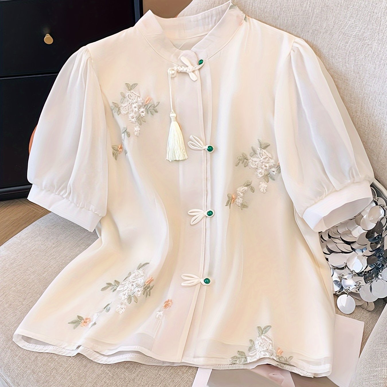 Women's chic floral blouse with green leaves & tassel details, ruffled cuffs, machine washable, perfect for spring/summer, casual chic style, button-up front, polyester fabric.