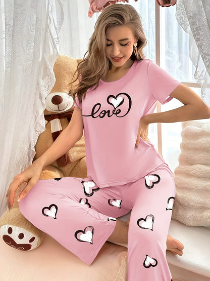 Stylish pink heart print pajama set for women with comfy short sleeve top and long pants, made of breathable polyester blend fabric.