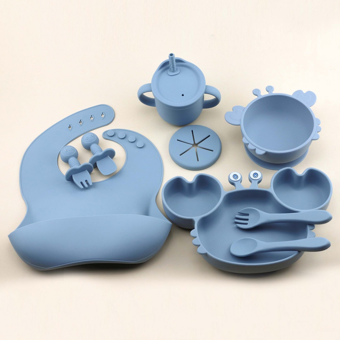 Set of 9 pieces of Silicone Feeding Essentials for Babies and Toddlers, featuring Silicone Bib, Suction Plate, Suction Bowl, Suction Straw Cup/Snack Cup, Spoon and Fork, Licking Spoon and Fork, all made of Food Grade Silicone in adorable shapes, offering