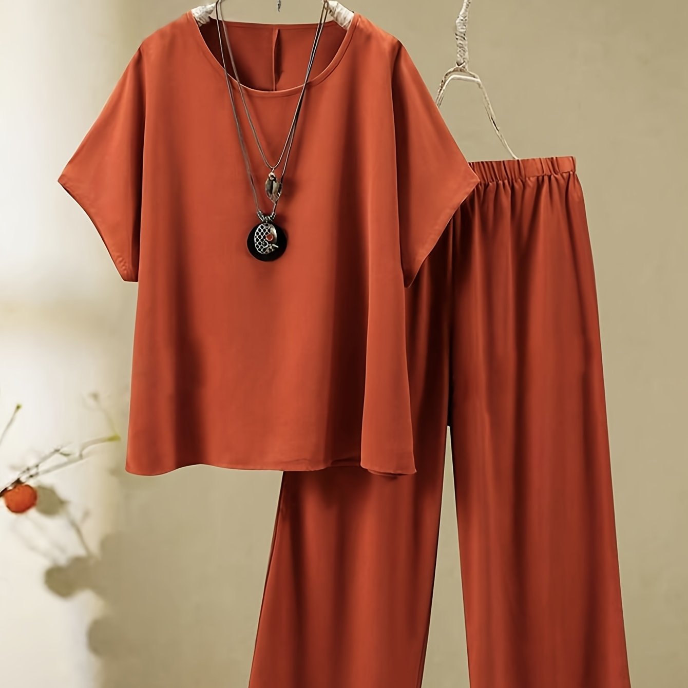 New plus-size vacation set includes round-neck short-sleeve top and long pants made from soft, sturdy fabric, perfect for women.