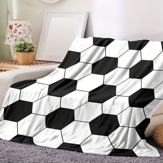 Soft and cozy football-themed blanket for kids made of flannel, featuring a hexagonal black and white soccer ball pattern. Perfect for bed, sofa, travel, and camping. Ultra-soft, lightweight, and warm. Machine washable. Ideal for both bed and sofa.