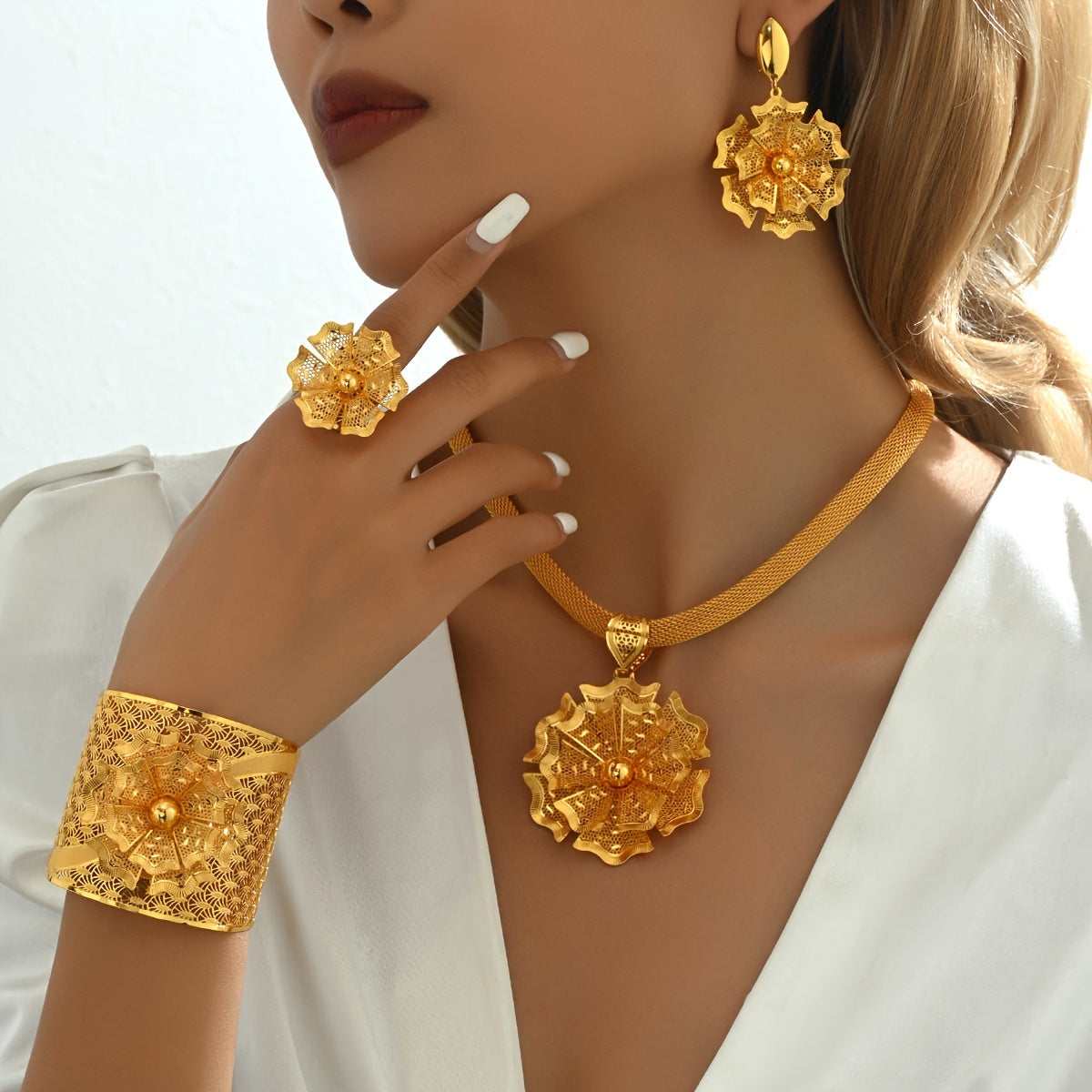 Luxurious five-piece bridal wedding accessories set featuring intricate flowers, stunning bracelets, rings, earrings, pendants, and necklaces in a bold ethnic design. This golden jewelry set is perfect for special occasions like banquets and vacations.