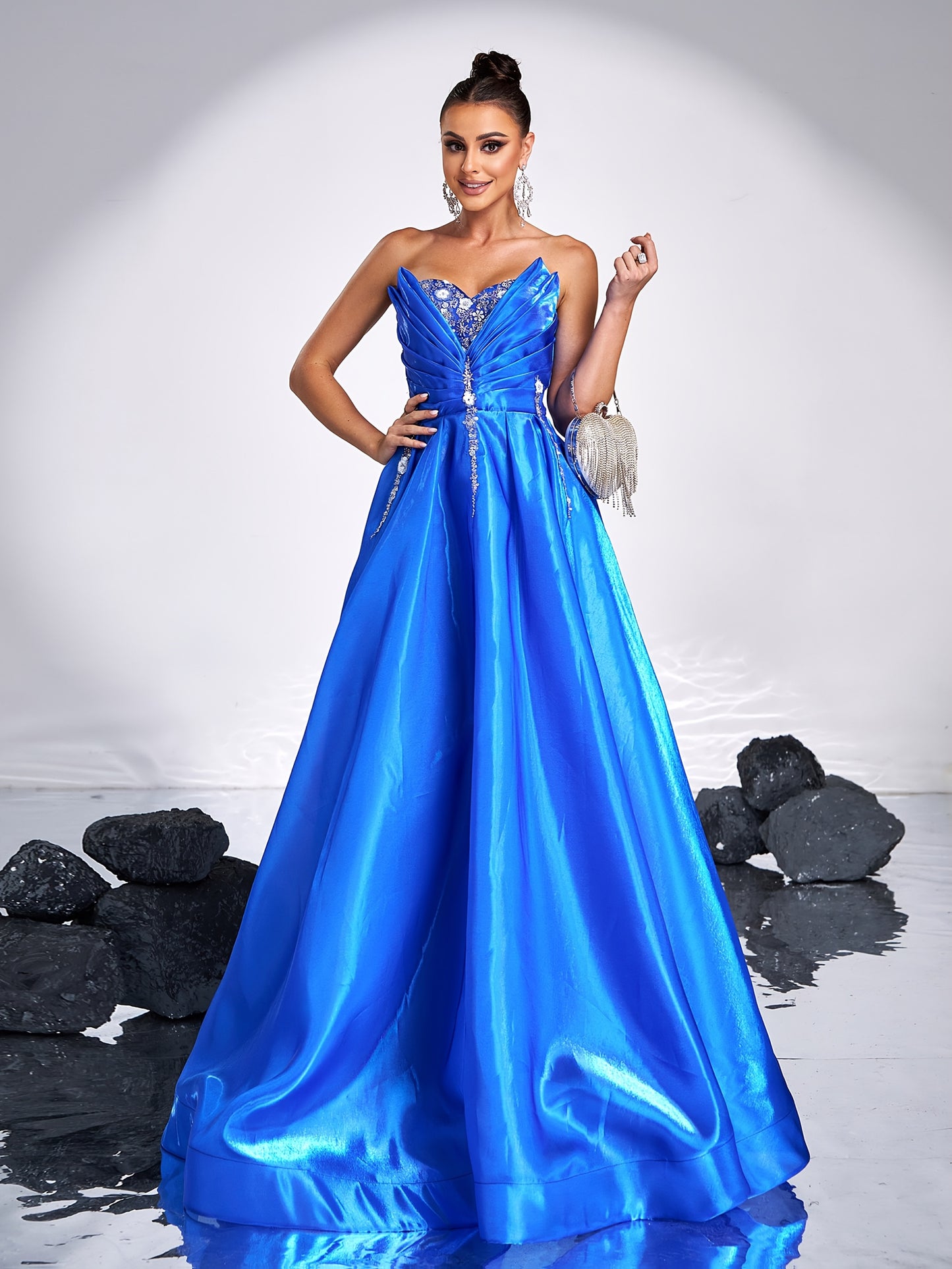 Elegant royal blue satin tube dress with rhinestone detailing and backless design, perfect for parties and formal events. Off-shoulder gown with flowing skirt and structured silhouette.