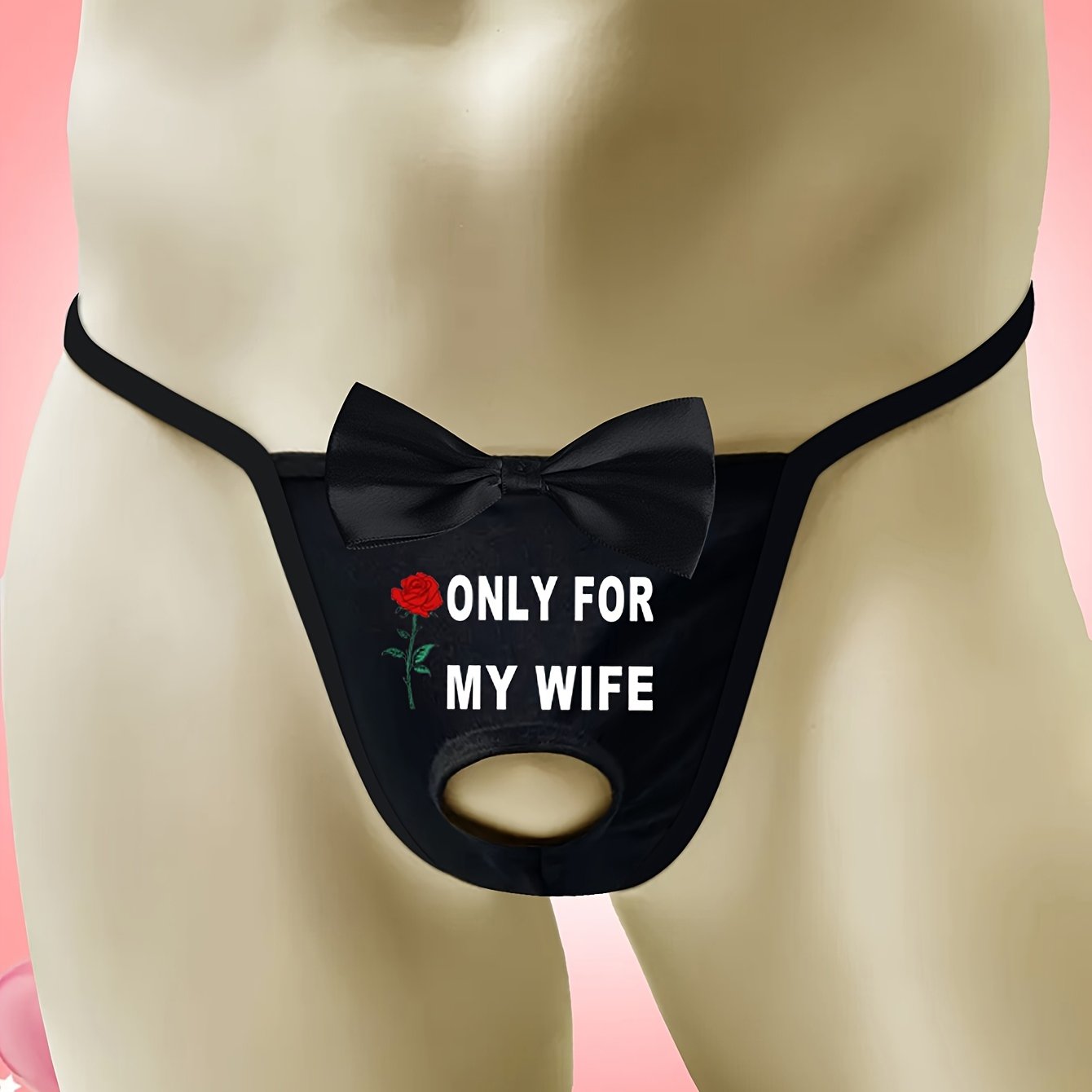 Men's sexy black thong with front cut-out and bow detail, featuring "ONLY FOR MY WIFE" red rose print. Made with comfortable, breathable polyamide (90%) and elastane (10%) knit fabric.