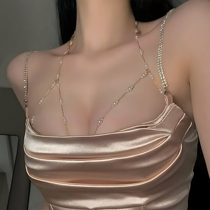 The woman personifies grace and refinement in a stunning body chain adorned with golden imitation pearls, ideal for adding a touch of glamour to any party or night out.