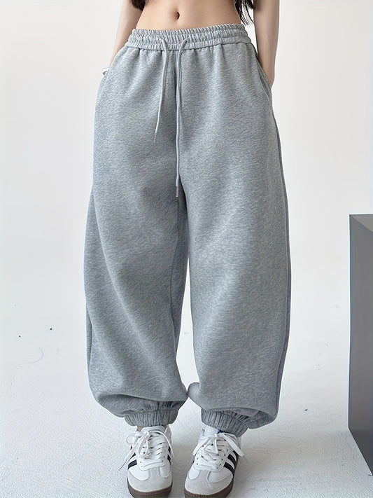 Women's loose sweatpants for fall & winter, with drawstring waist, in solid color.