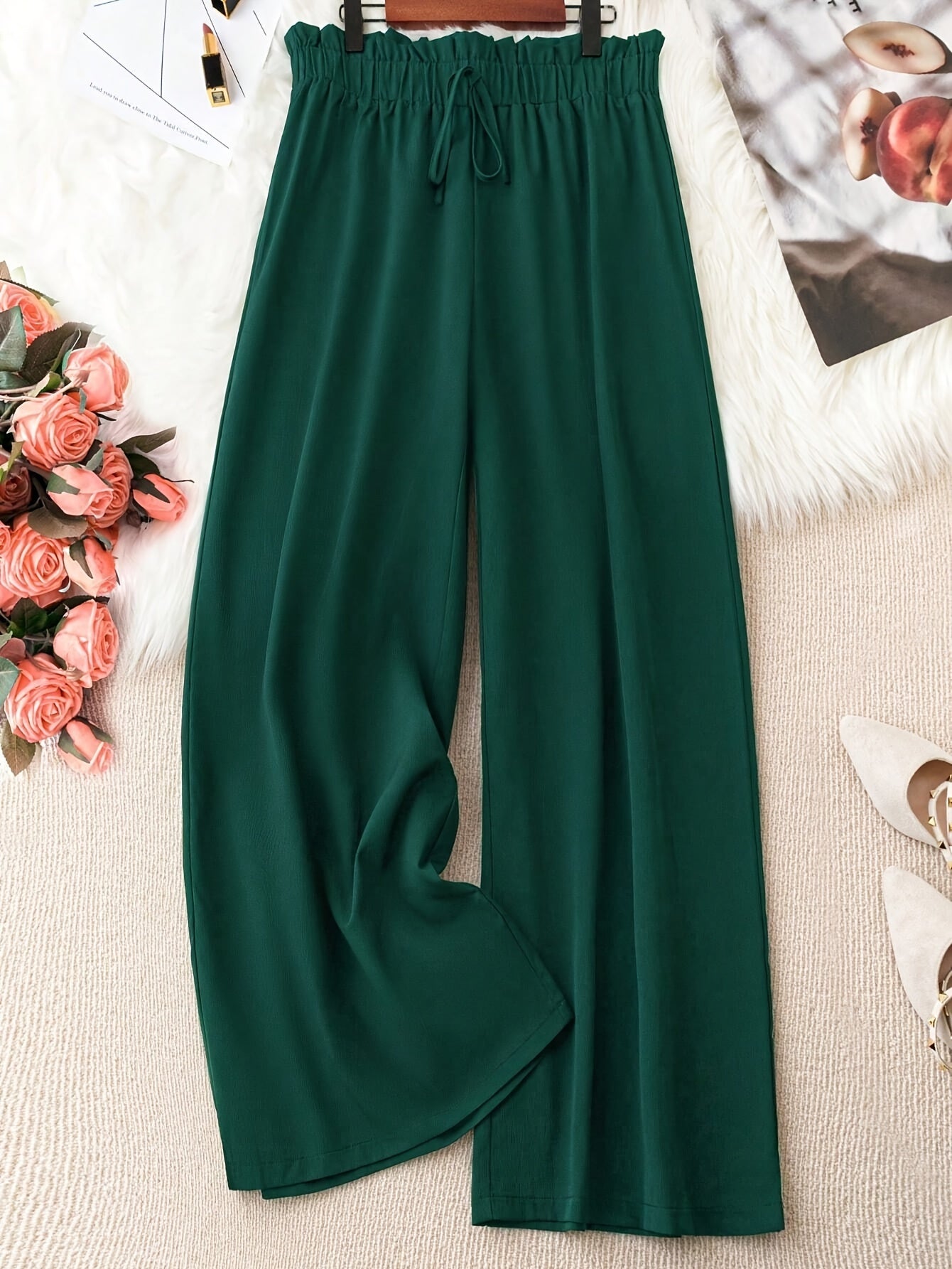 Flowy green polyester wide-leg pants with a tie waist, high-rise fit, and smooth fabric. Suitable for casual or office wear in spring/summer/fall. Machine washable.