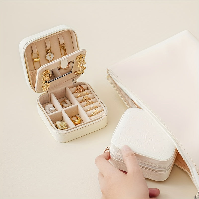 Compact and stylish portable jewelry box with mirror, zipper, and flip cover. Ideal for storing rings, earrings, and necklaces on-the-go.