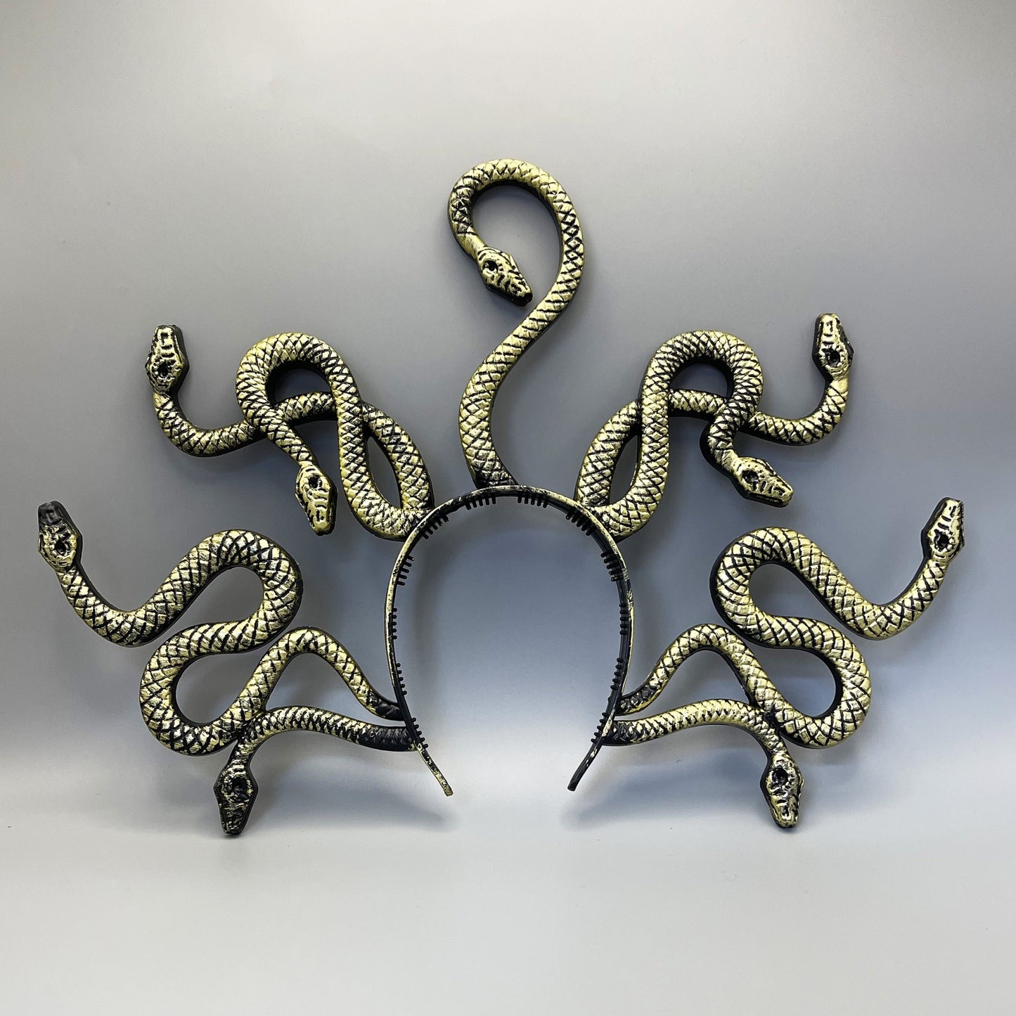 An antique distressed Medusa snake headband perfect for Halloween parties and spooky gatherings, adding a vintage touch to your costume.