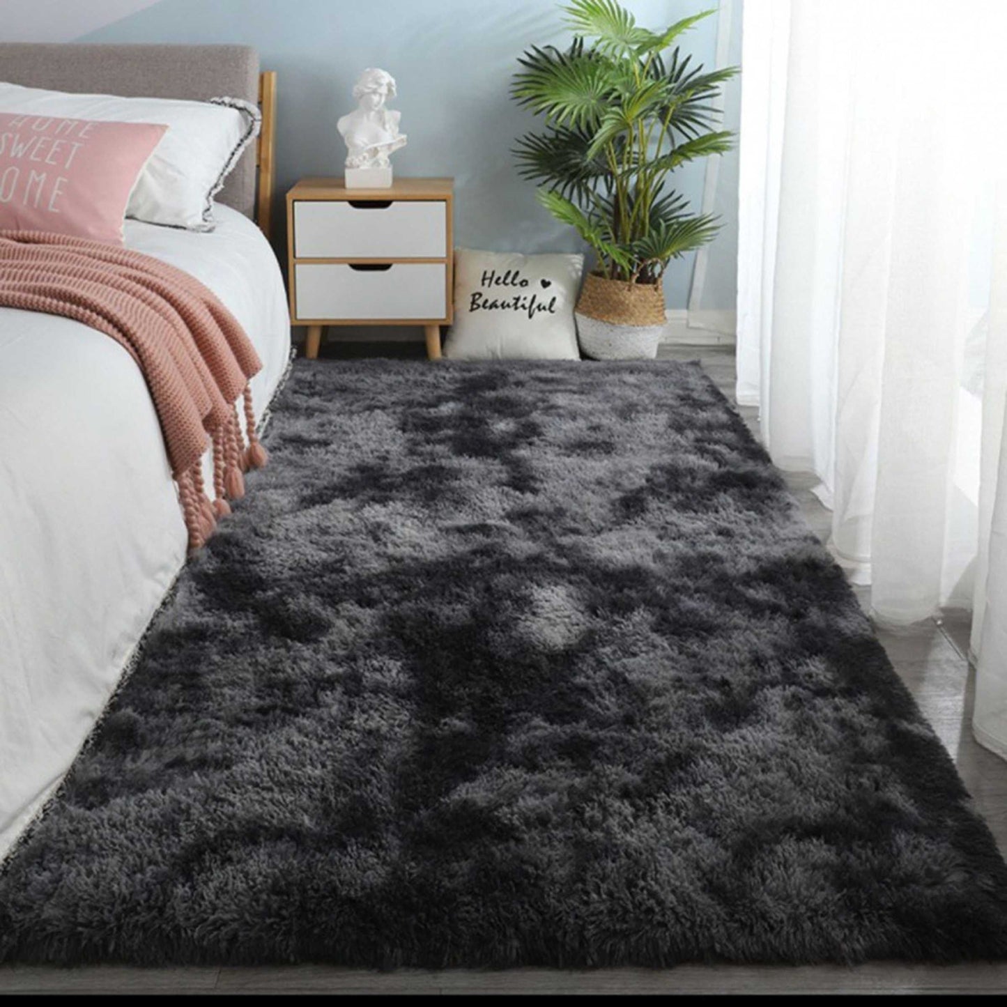 One piece of plush, fluffy area rug designed for bedrooms. This soft, fuzzy shaggy rug is black in color and rectangular in shape, perfect for adding warmth to your living room. It features a non-slip bottom to ensure safety. Great for Halloween or