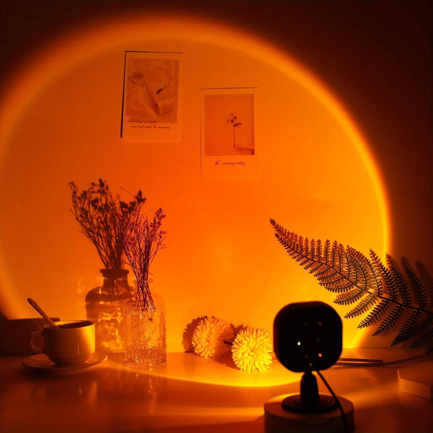 USB-powered LED sunset lamp projector creates warm orange ambiance for bedroom and living room decor. Suitable for photography. Energy-efficient tabletop design.