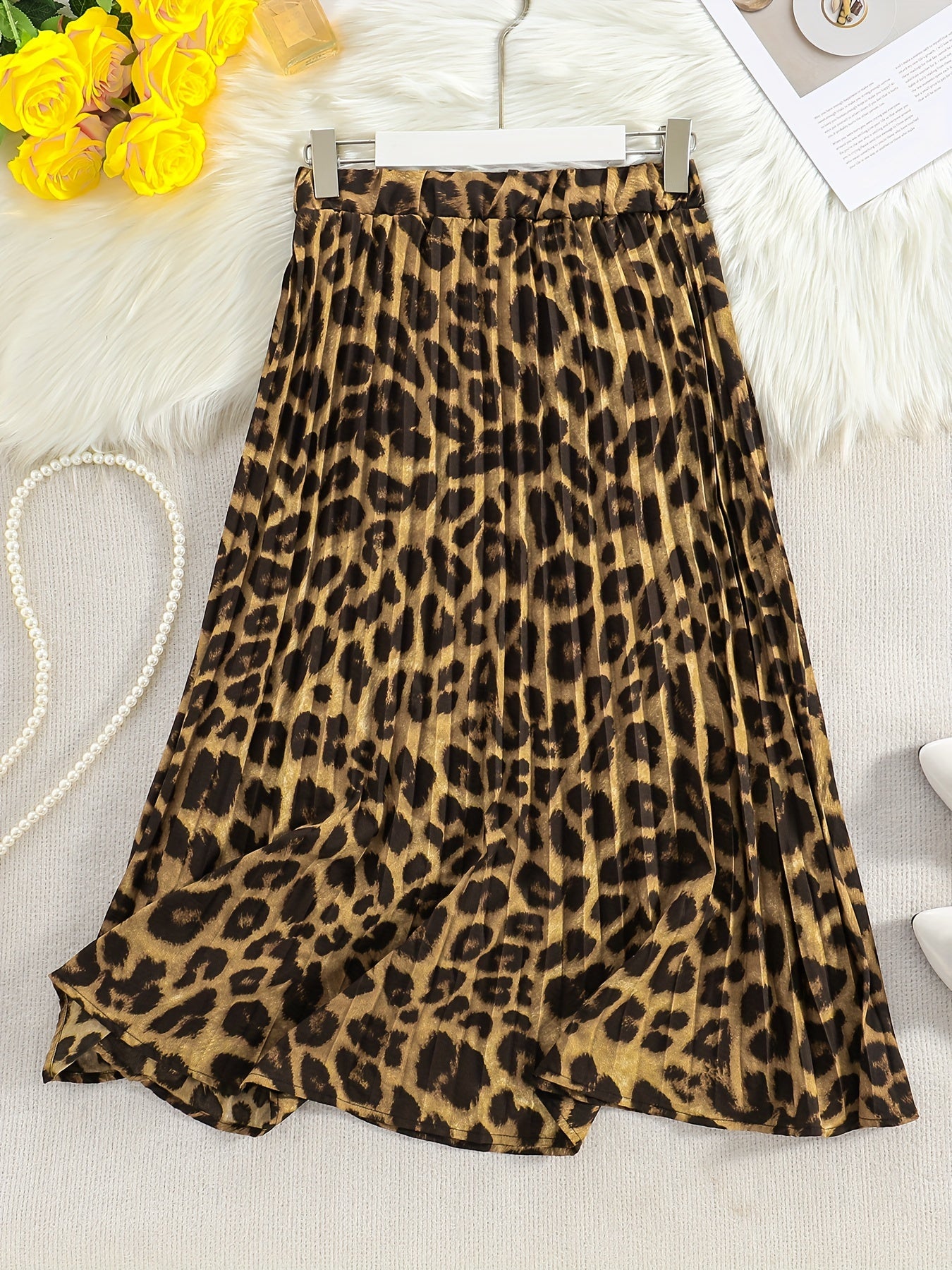 Stylish leopard print midi skirt for women, made of polyester with an umbrella hem. Versatile for all seasons, offering an elegant and conventional look. Available in all sizes worldwide.