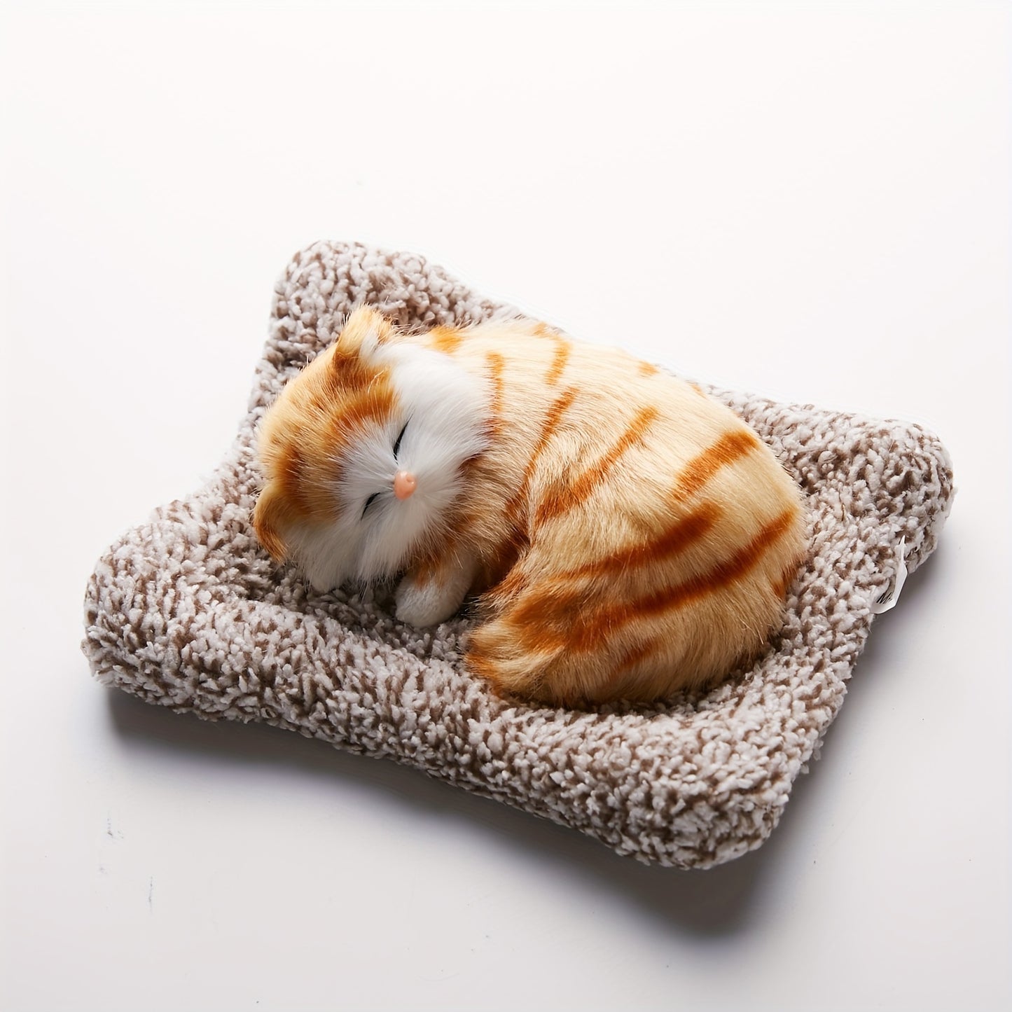 Fluffy sleeping cat figurine.