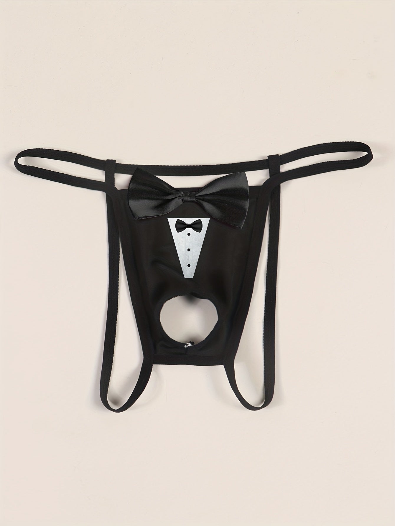 Sexy low-rise jockstrap for men with playful tie print and front bow detail. Breathable and stretchy black fabric with open crotch design for comfort and style.