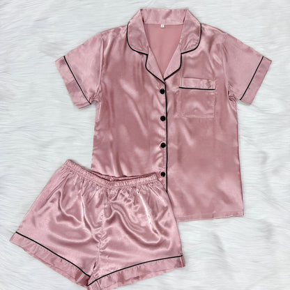 Casual satin pajama set for women with short sleeve top, lapel buttons, and shorts for a comfortable fit.