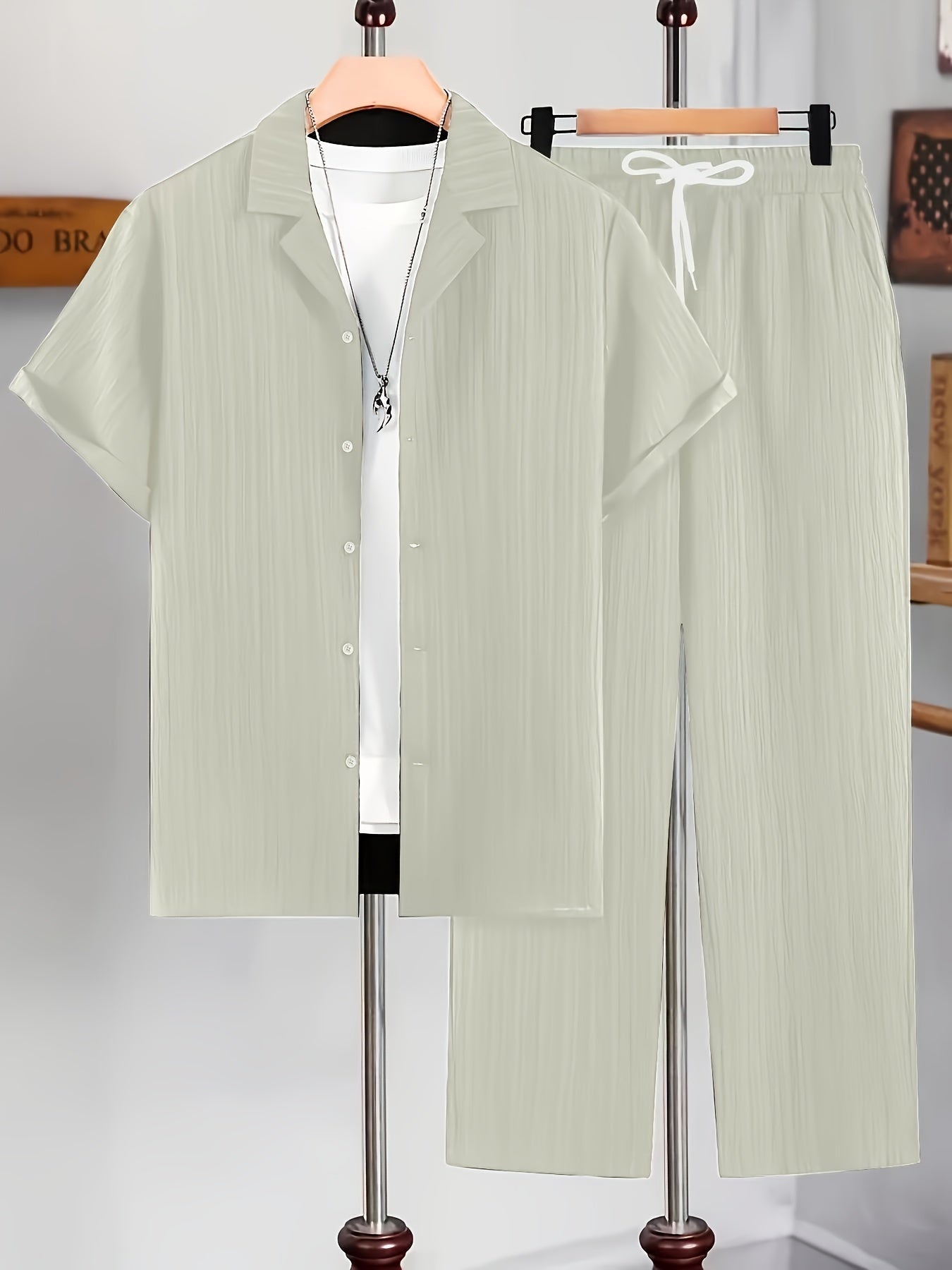 Men's casual two-piece set for summer leisure: short sleeve button-up shirt and drawstring pants.