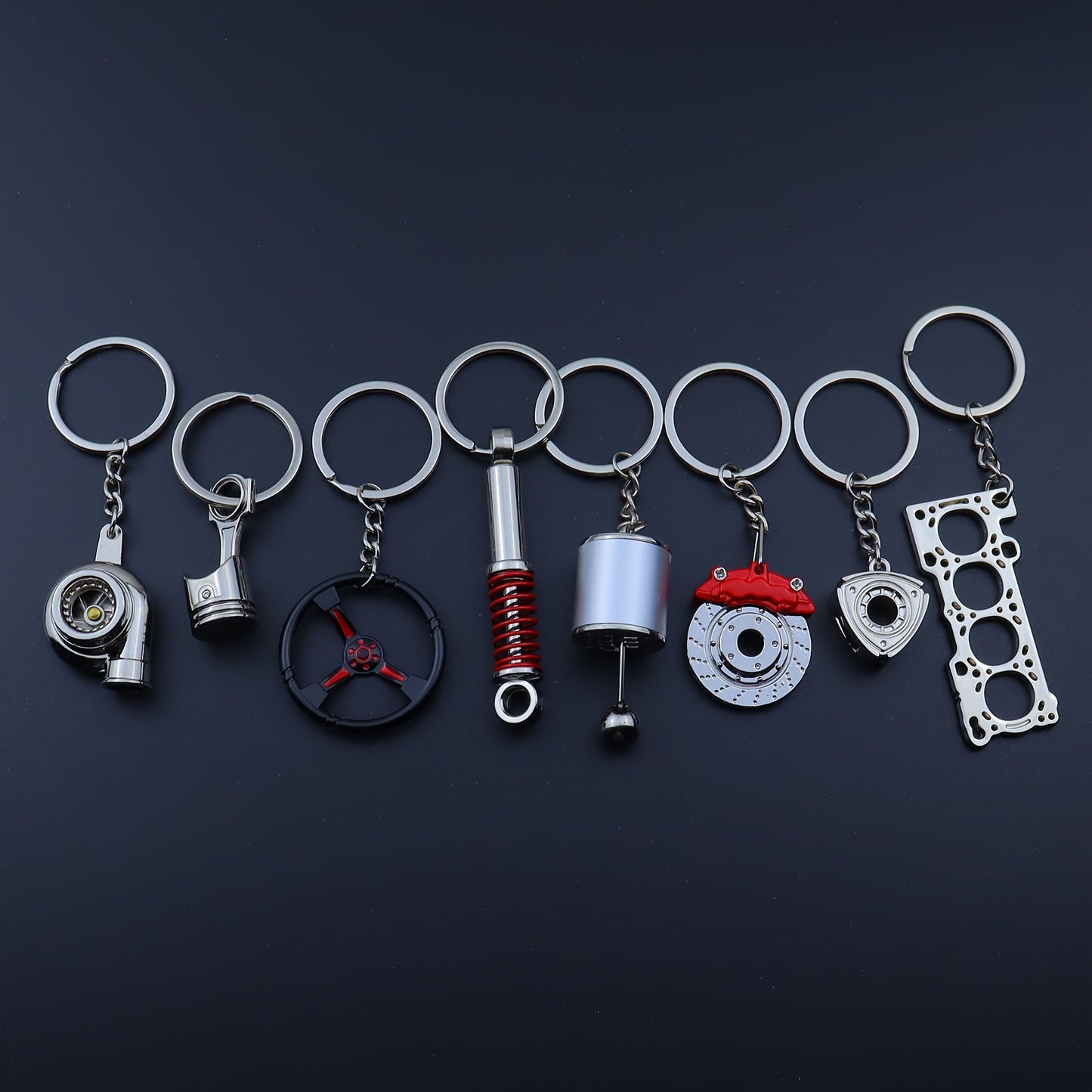 Keychains for creative car modifications, including piston, brake disc, gear, turbocharger, small rotor, shock absorber, engine blade, and steering wheel designs. Perfect for car enthusiasts and as a unique gift.